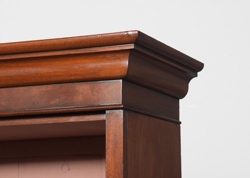 A tall mid-Victorian mahogany open bookcase featuring a double-bay design with adjustable shelves set upon a solid plinth base. View IV