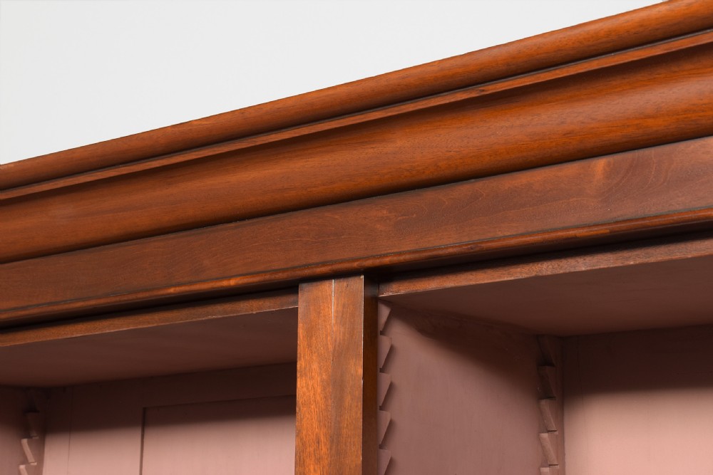 A tall mid-Victorian mahogany open bookcase featuring a double-bay design with adjustable shelves set upon a solid plinth base. View VII