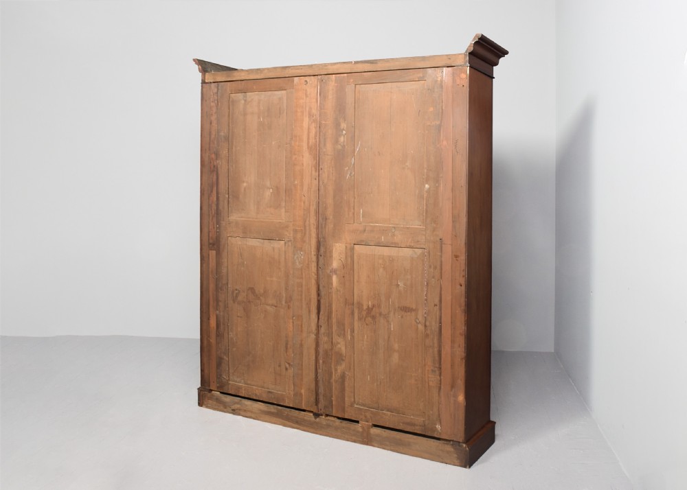 A tall mid-Victorian mahogany open bookcase featuring a double-bay design with adjustable shelves set upon a solid plinth base. View IX
