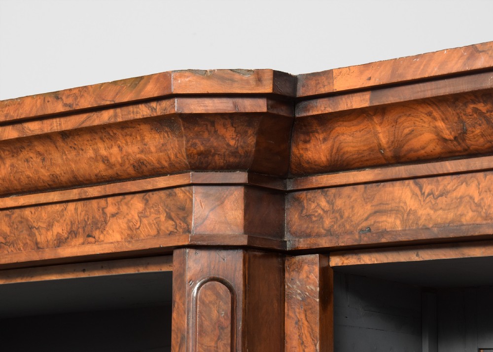 A large three-section Victorian open bookcase made from burr walnut with a breakfront centre section, adjustable shelves, and a plinth base. View IV