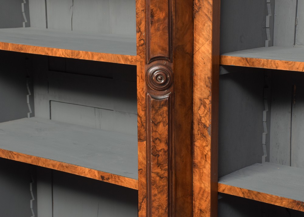 A large three-section Victorian open bookcase made from burr walnut with a breakfront centre section, adjustable shelves, and a plinth base. View V