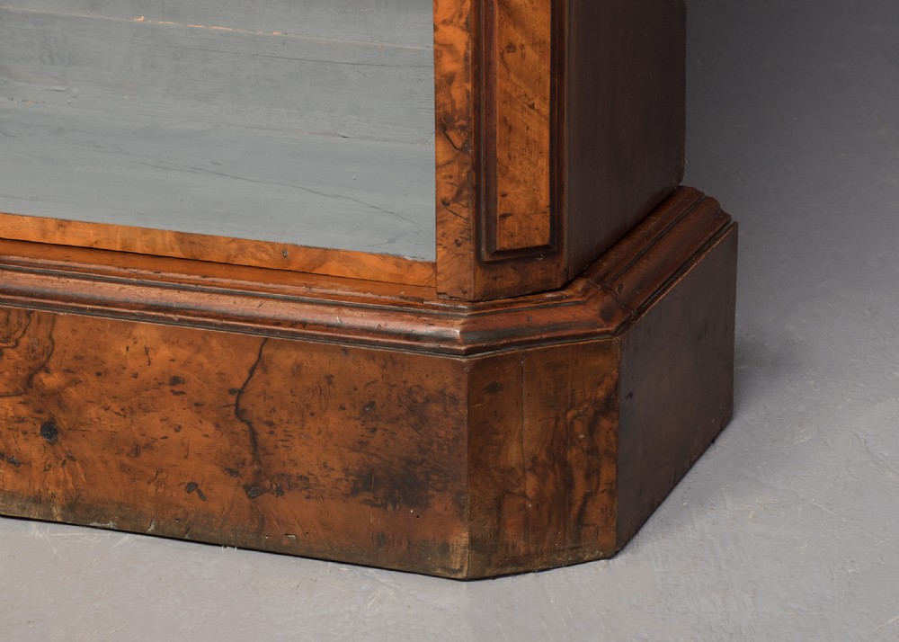 A large three-section Victorian open bookcase made from burr walnut with a breakfront centre section, adjustable shelves, and a plinth base. View VII