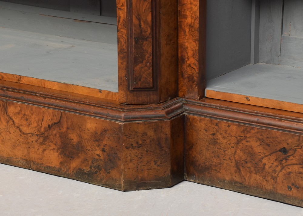 A large three-section Victorian open bookcase made from burr walnut with a breakfront centre section, adjustable shelves, and a plinth base. View VIII