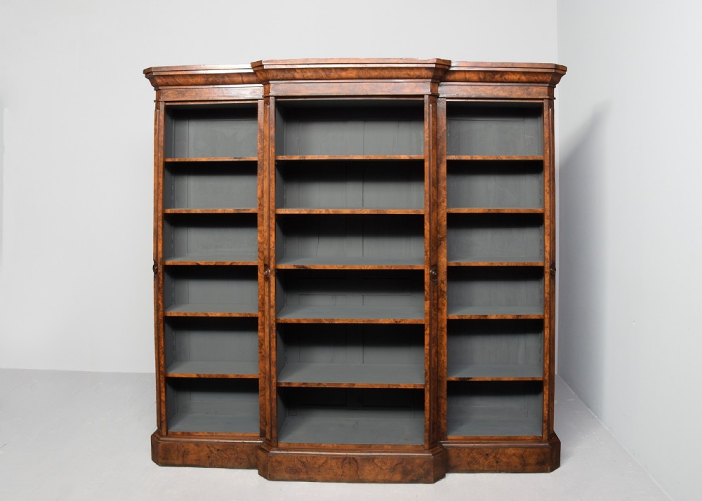 A large three-section Victorian open bookcase made from burr walnut with a breakfront centre section, adjustable shelves, and a plinth base. View IX