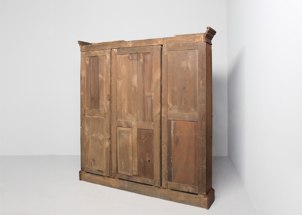 A large three-section Victorian open bookcase made from burr walnut with a breakfront centre section, adjustable shelves, and a plinth base. View X