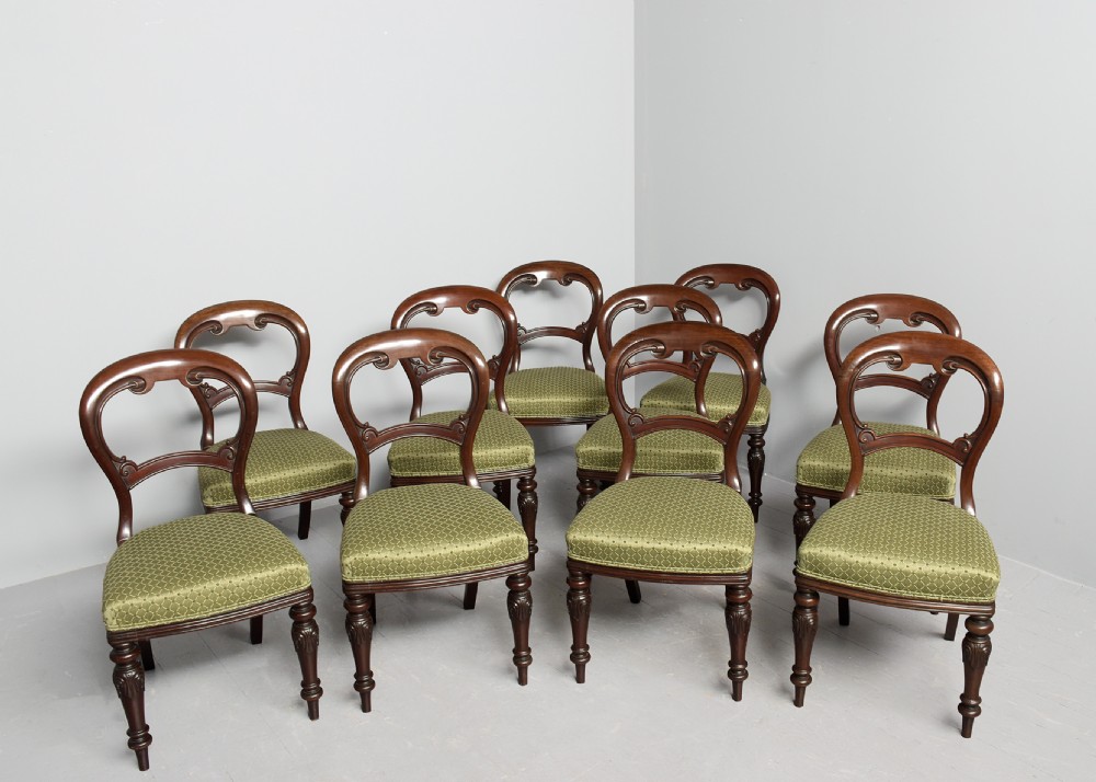 A set of ten Victorian mahogany balloon-back dining chairs with green patterned upholstered seats and turned front legs. View II