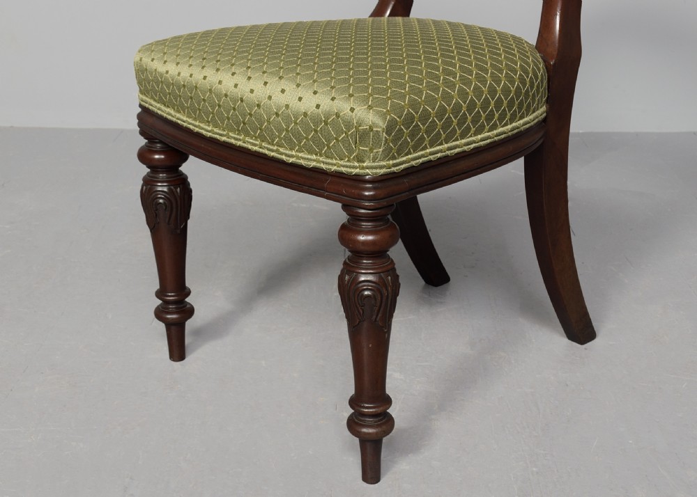 A set of ten Victorian mahogany balloon-back dining chairs with green patterned upholstered seats and turned front legs. View VII