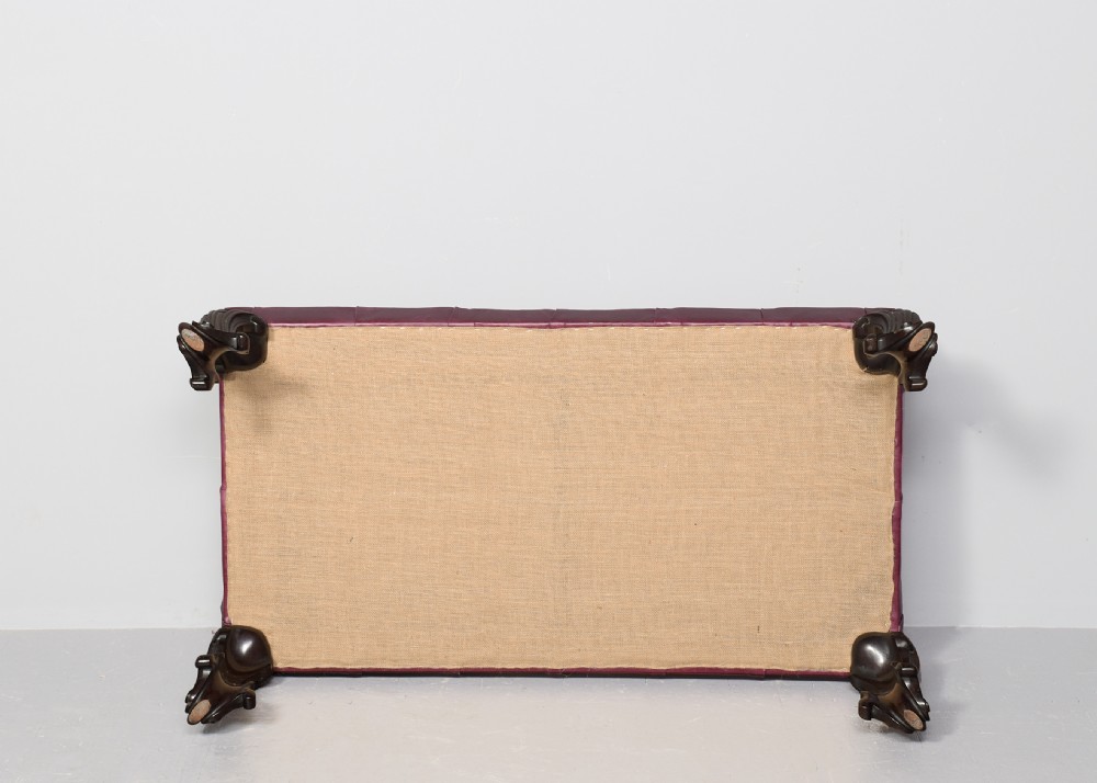 A large rectangular Georgian-style footstool upholstered in deep buttoned burgundy hide leather with mahogany cabriole legs. View VIII