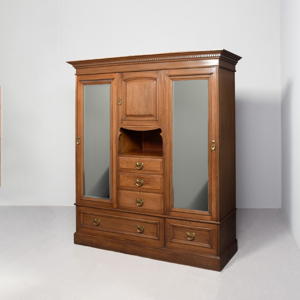 Art Nouveau-influenced three-section straight-grained walnut wardrobe