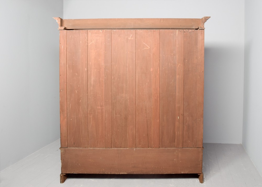 A straight-grained walnut three-section wardrobe with two tall mirrored doors flanking a central column containing a small cupboard, open shelf, and multiple drawers. View X