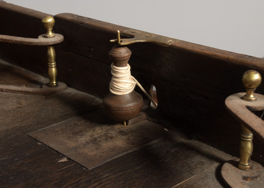 A George IV freestanding dark oak skittles game table featuring turned fluted legs and internal brass game guides. View V