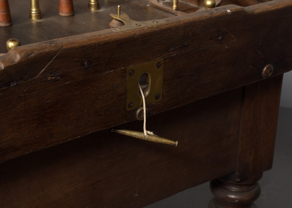 A George IV freestanding dark oak skittles game table featuring turned fluted legs and internal brass game guides. View VI