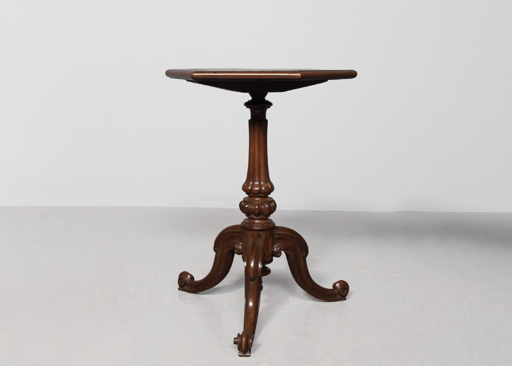 A pair of rosewood occasional tables featuring hexagonal tops, turned carved pedestals, and scrolled tripod legs. View V