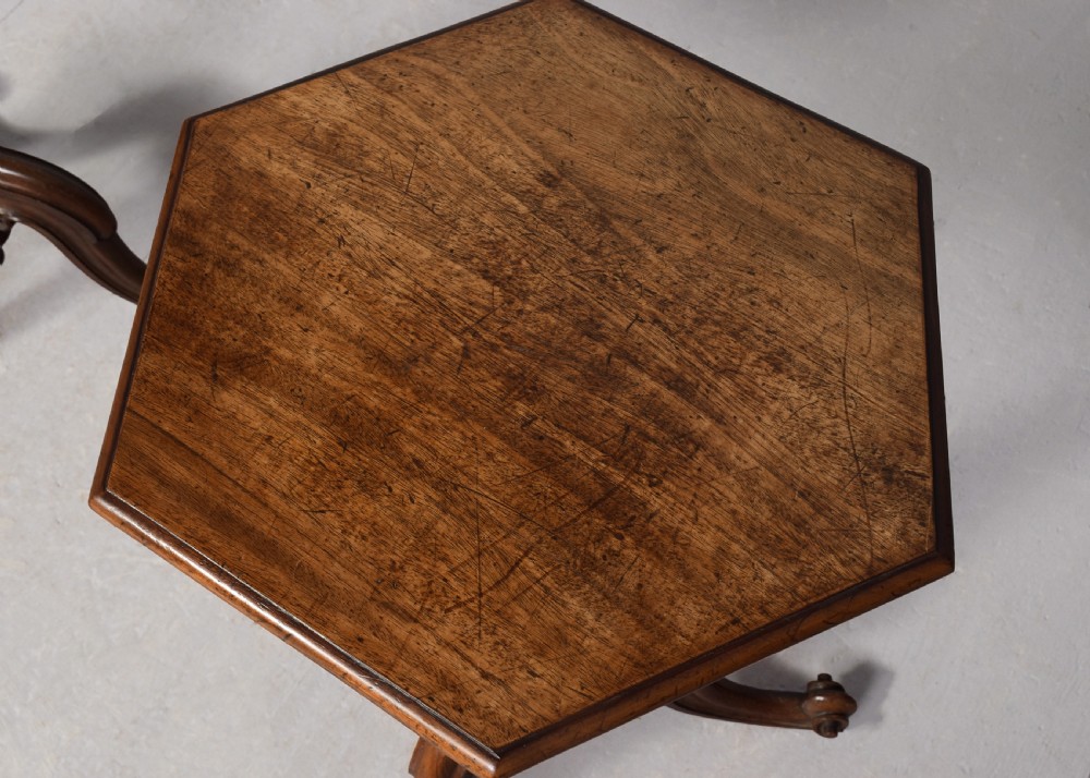 A pair of rosewood occasional tables featuring hexagonal tops, turned carved pedestals, and scrolled tripod legs. View VII