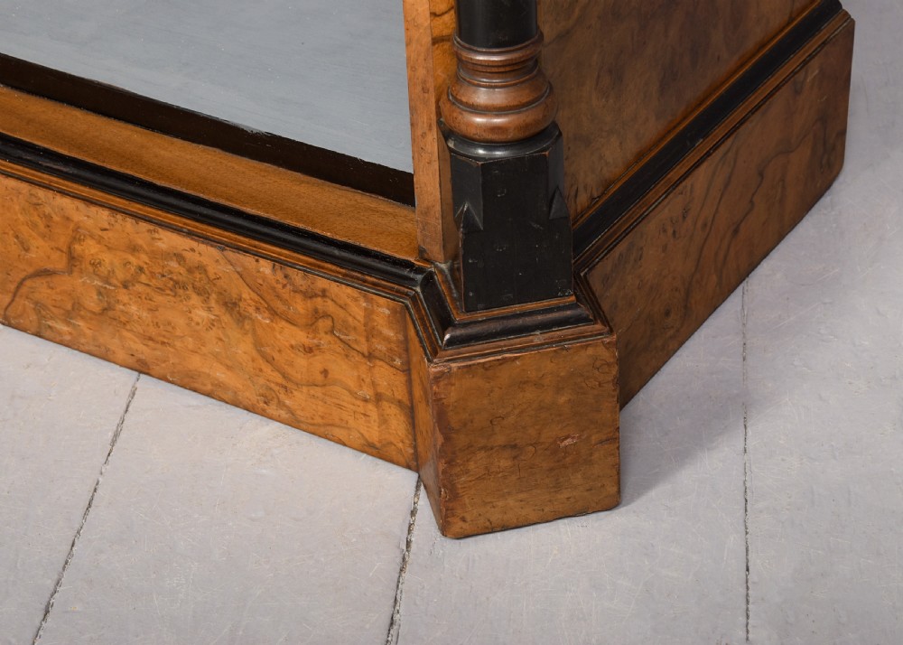 A low three-section open bookcase made of figured burr walnut featuring ebonised turned columns and a grey painted interior. View VII