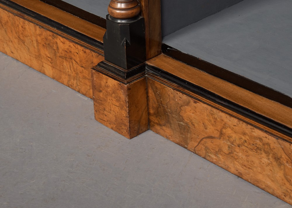 A low three-section open bookcase made of figured burr walnut featuring ebonised turned columns and a grey painted interior. View VIII