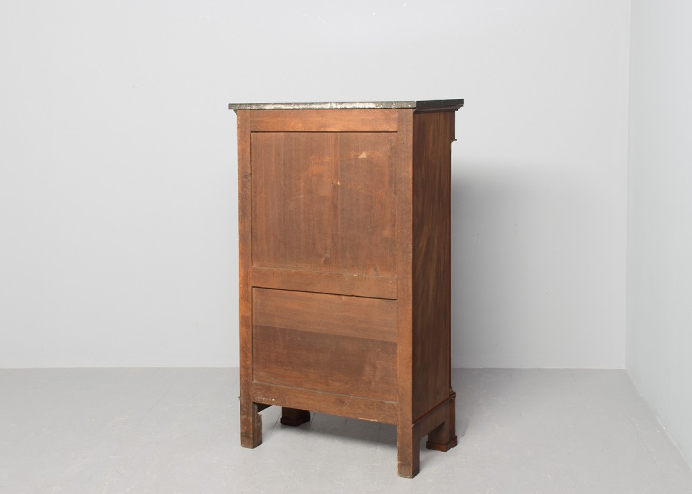 A tall mahogany secretaire abattant featuring a dark marble top, a drop-front writing panel flanked by turned columns, and three lower drawers with brass handles. View IX