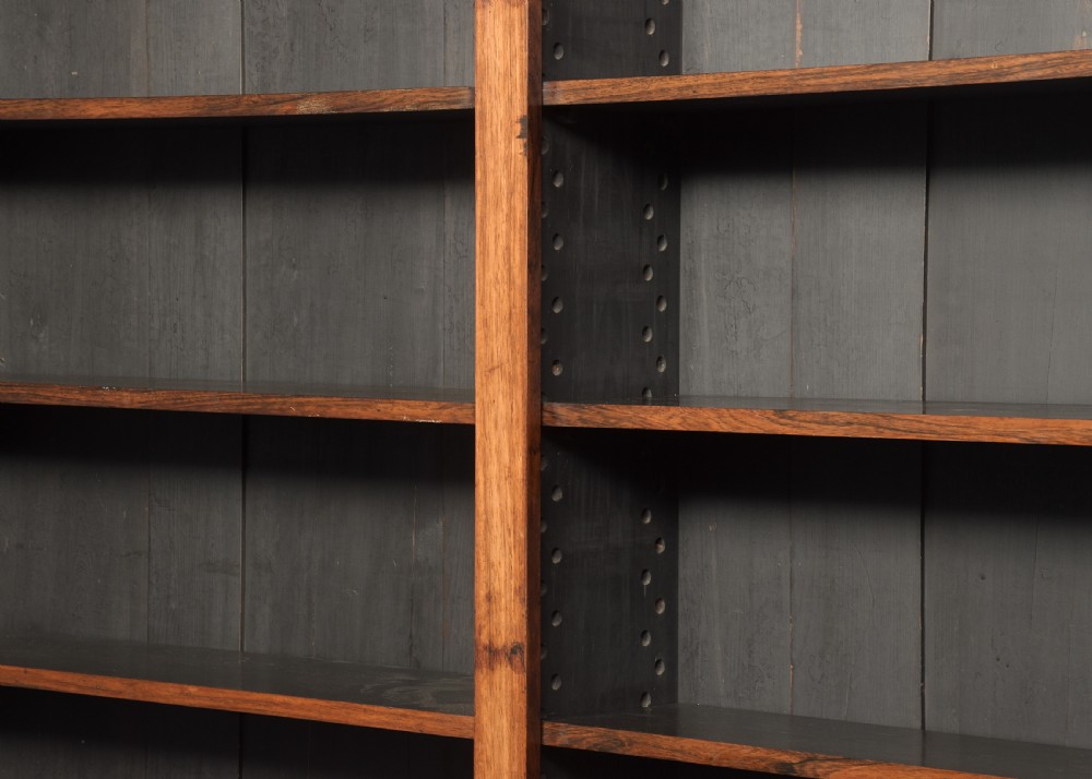 A tall William IV rosewood open bookcase featuring two upper shelf sections over lower bays with carved corbels and a solid plinth base. View V