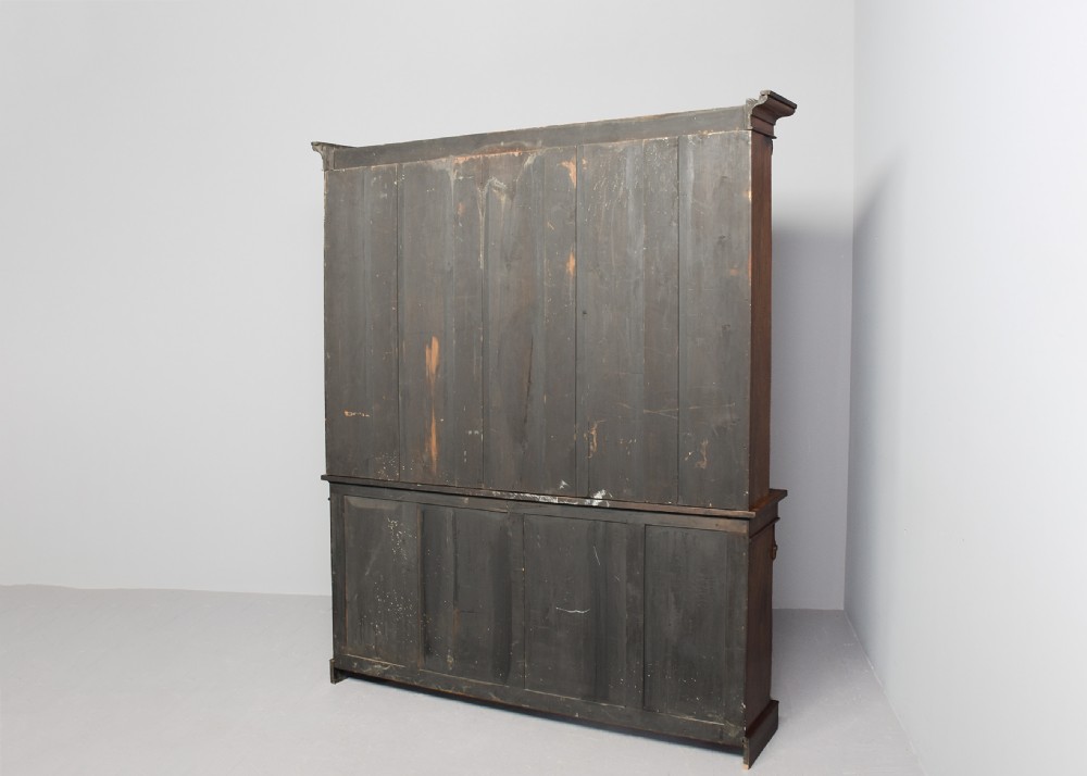 A tall William IV rosewood open bookcase featuring two upper shelf sections over lower bays with carved corbels and a solid plinth base. View XI