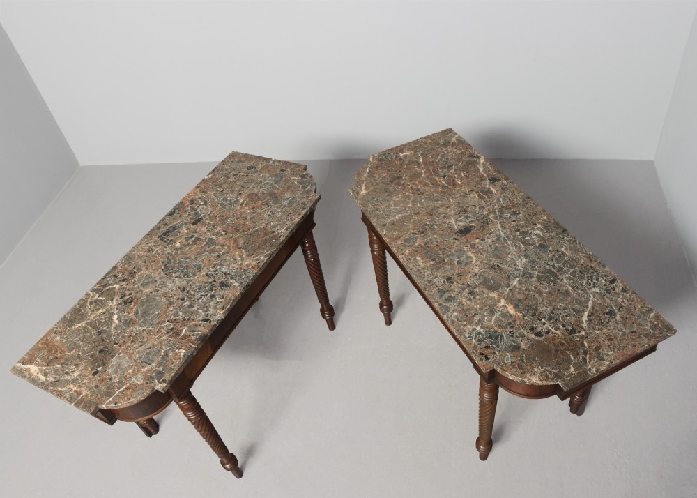 A pair of William IV mahogany break-front hall tables featuring grey marble tops and spiral-turned legs. View IV