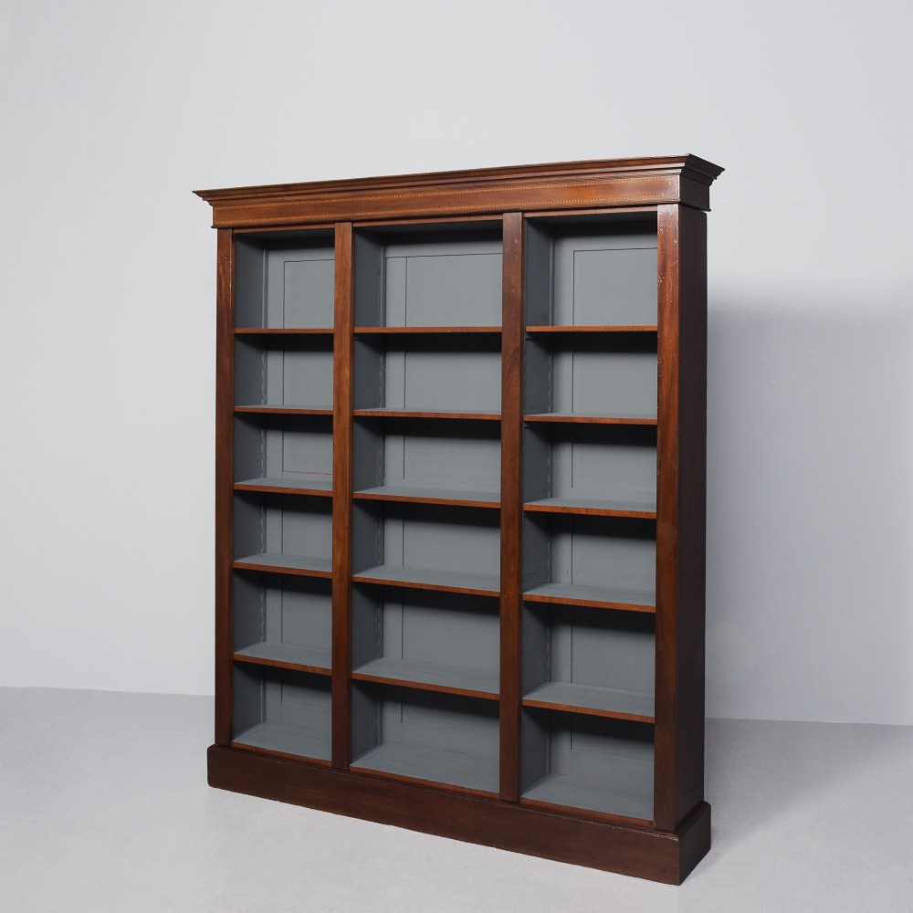 A large three-section mahogany open bookcase featuring adjustable shelves and fine inlay detailing along the top cornice. View III