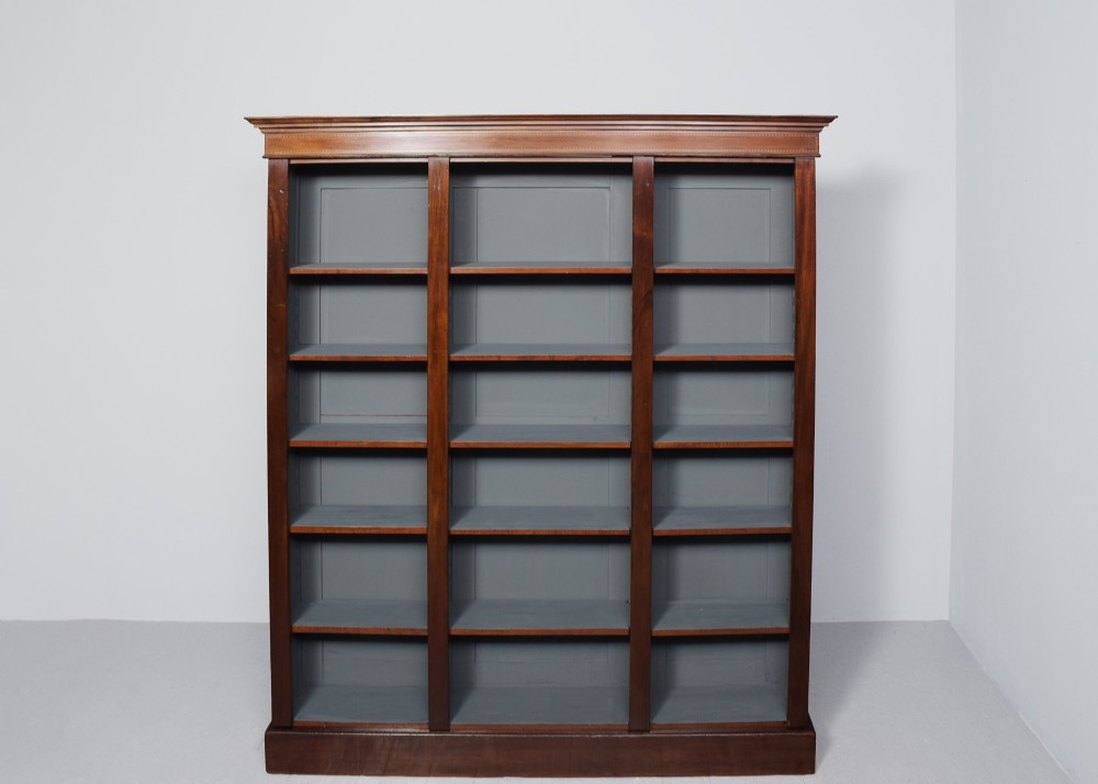 A large three-section mahogany open bookcase featuring adjustable shelves and fine inlay detailing along the top cornice. View VII