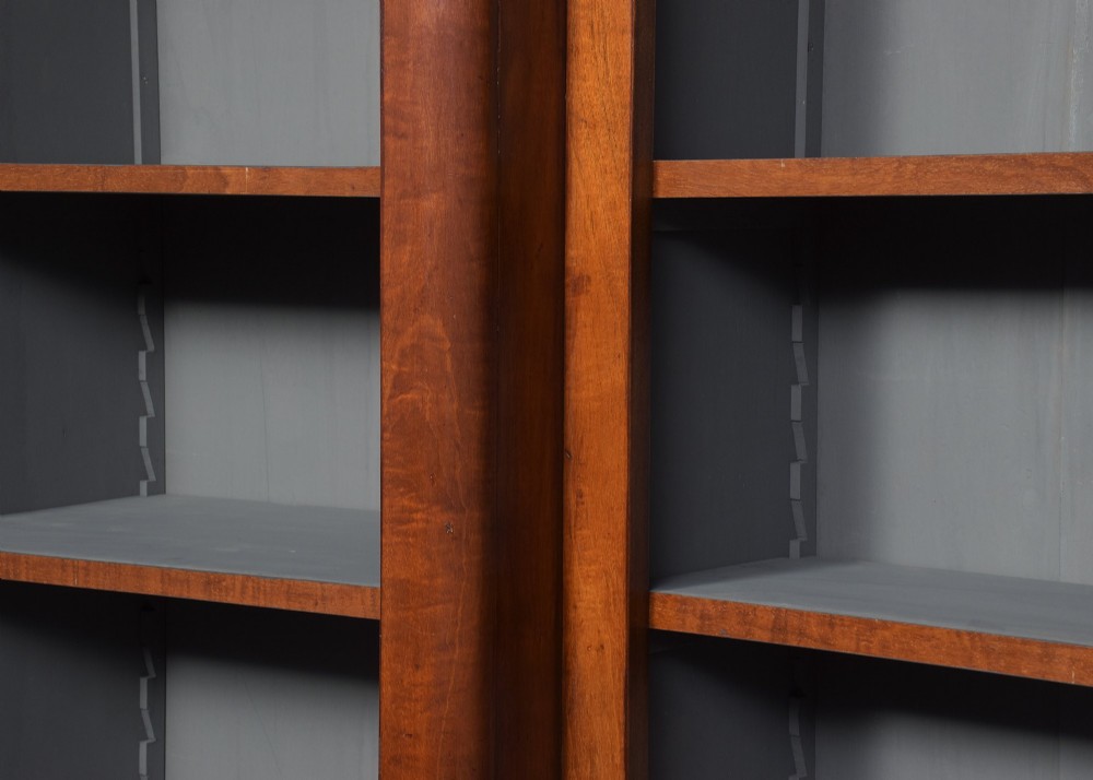 A large mid-Victorian three-section open mahogany bookcase with a breakfront centre, filled with rows of leather-bound books. View II