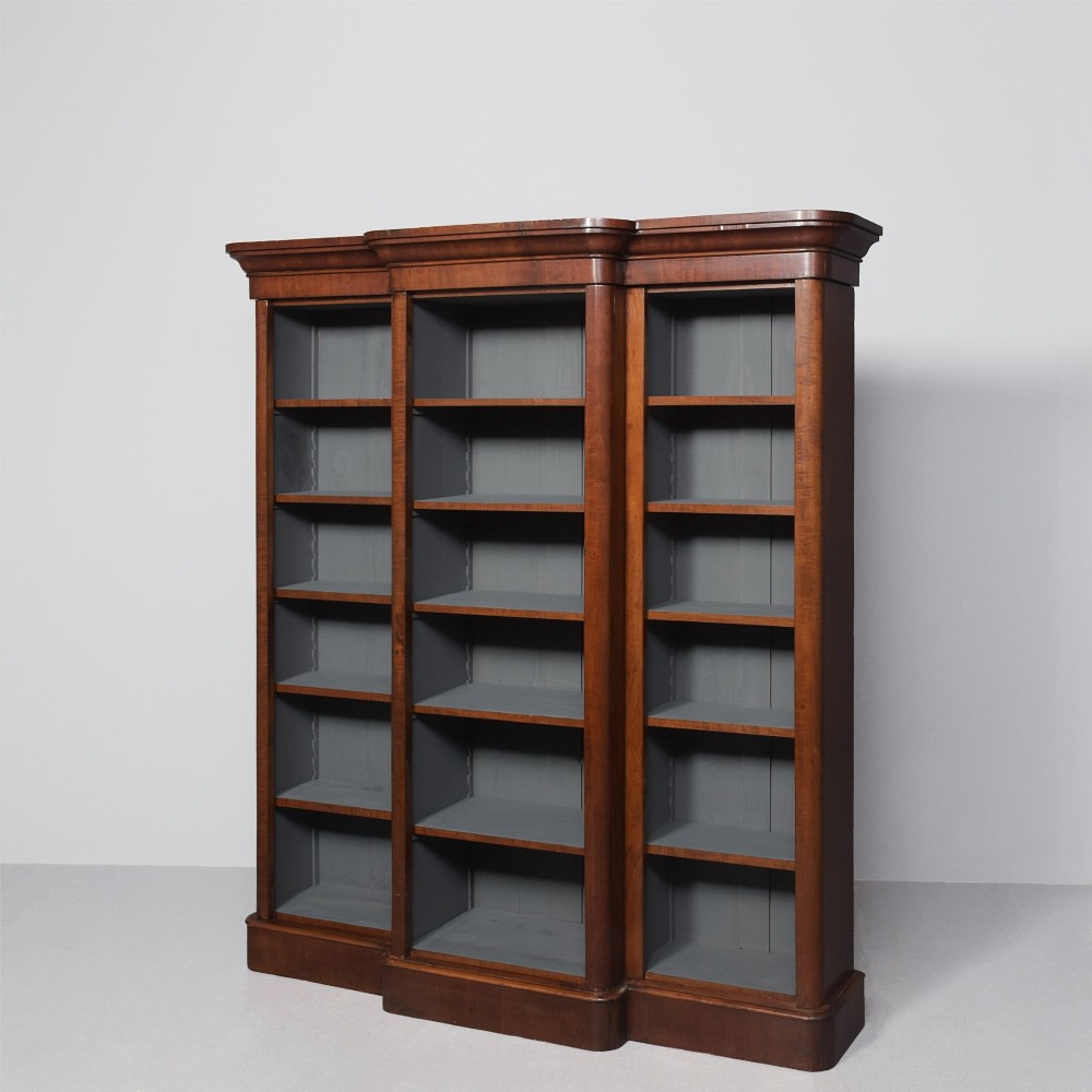 A large mid-Victorian three-section open mahogany bookcase with a breakfront centre, filled with rows of leather-bound books. View III