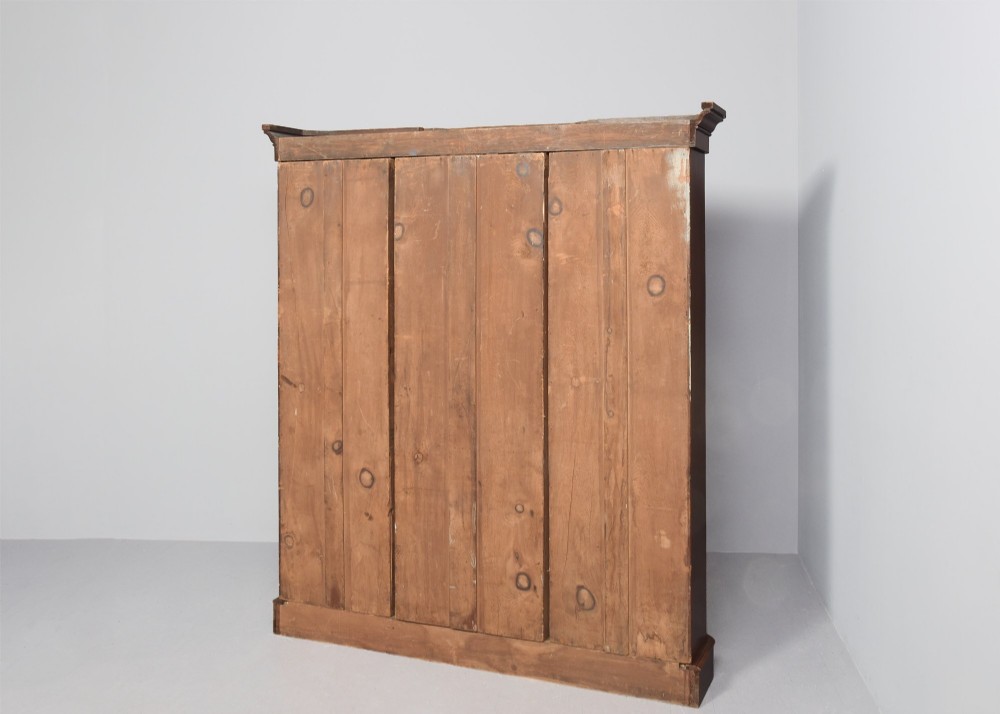 A large mid-Victorian three-section open mahogany bookcase with a breakfront centre, filled with rows of leather-bound books. View VIII