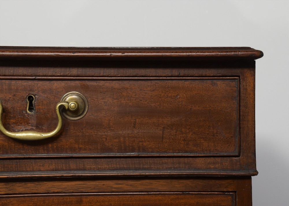 A large George III mahogany partners desk featuring a green leather writing surface, dual pedestals with brass swan-neck handles, and bracket feet. View VIII