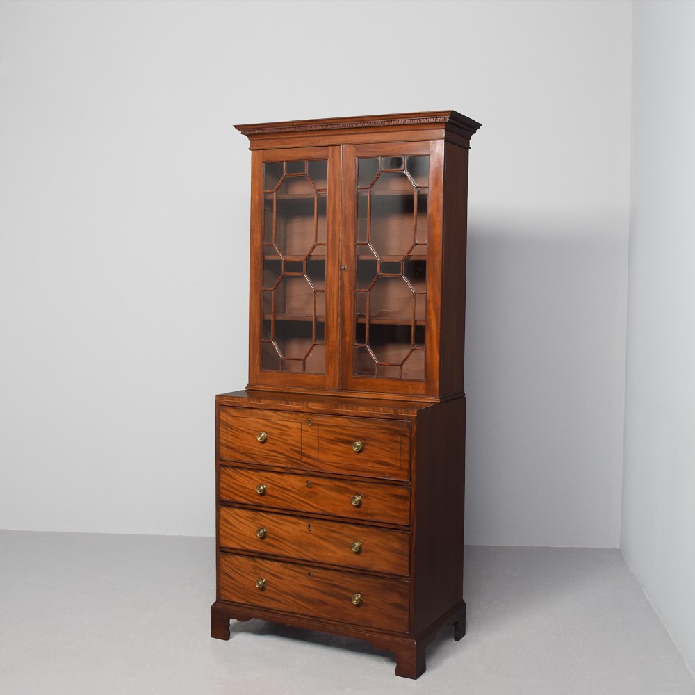 A late eighteenth-century George III mahogany secretaire bookcase featuring an upper glazed cabinet and a lower chest of drawers on bracket feet.