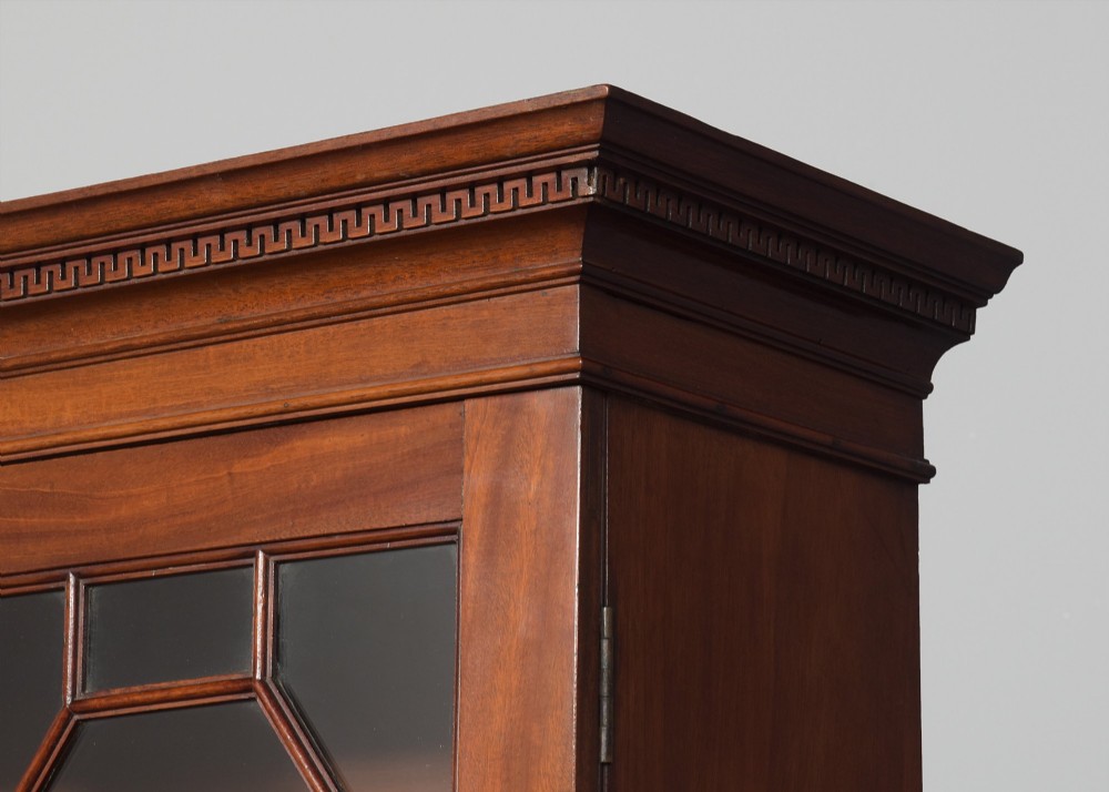 A late eighteenth-century George III mahogany secretaire bookcase featuring an upper glazed cabinet and a lower chest of drawers on bracket feet. View II