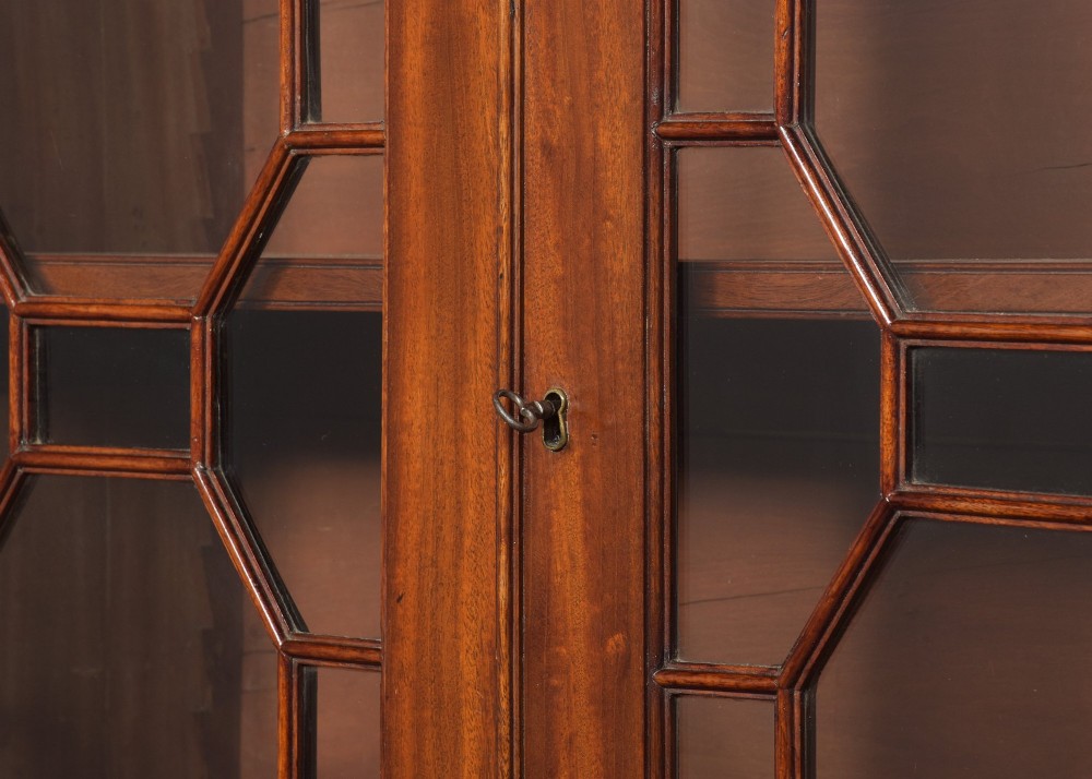 A late eighteenth-century George III mahogany secretaire bookcase featuring an upper glazed cabinet and a lower chest of drawers on bracket feet. View IV