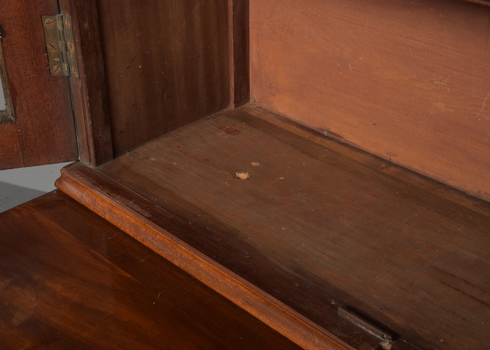 A late eighteenth-century George III mahogany secretaire bookcase featuring an upper glazed cabinet and a lower chest of drawers on bracket feet. View IX