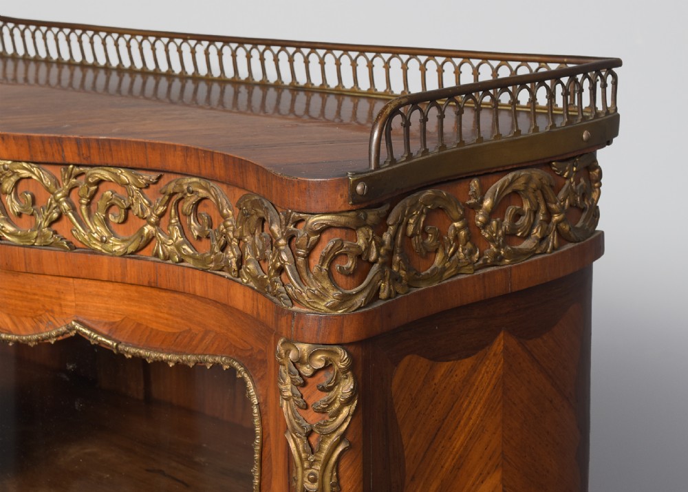 A nineteenth-century French style kingwood and walnut writing desk featuring an upper glazed display cabinet, brass top gallery, cabriole legs, and gilded metal mounts. View II