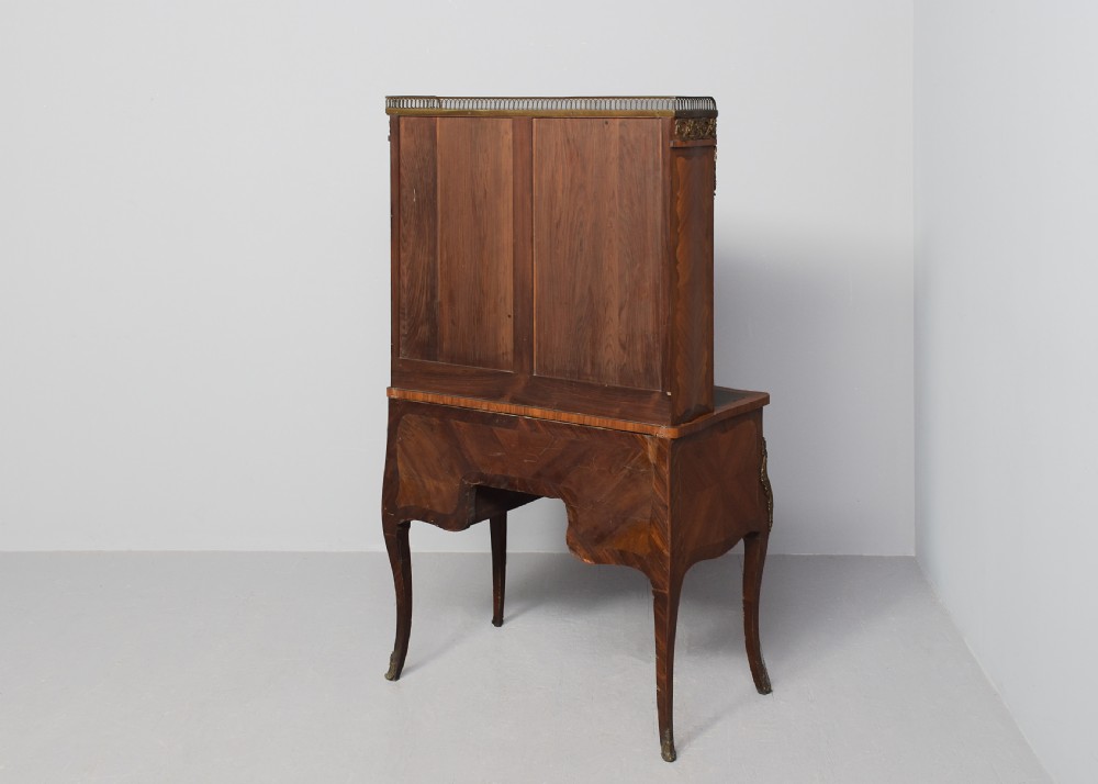 A nineteenth-century French style kingwood and walnut writing desk featuring an upper glazed display cabinet, brass top gallery, cabriole legs, and gilded metal mounts. View XI