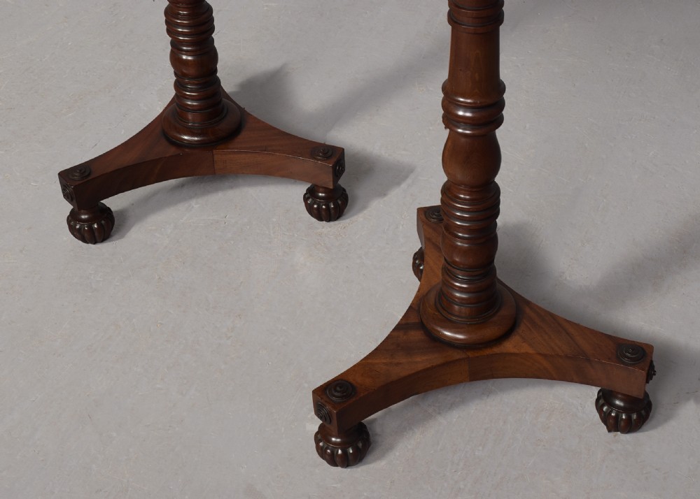 A pair of dark mahogany William IV wine tables featuring hexagonal tops, turned column pedestals, and triform bases. View IV