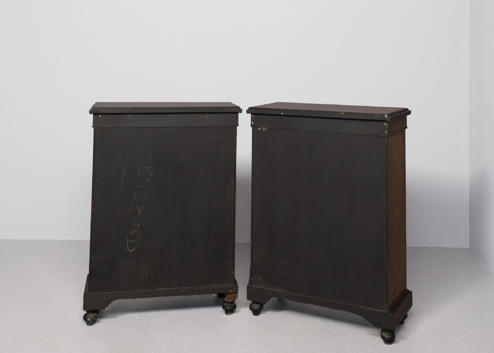 A pair of Victorian burr walnut pier cabinets with single glazed doors, ebonised trim, ormolu corner mounts, and oval porcelain plaques. View VIII