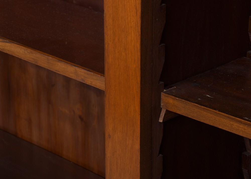A tall mid-Victorian mahogany three-section open bookcase featuring a moulded top cornice and a solid plinth base filled with books. View VI