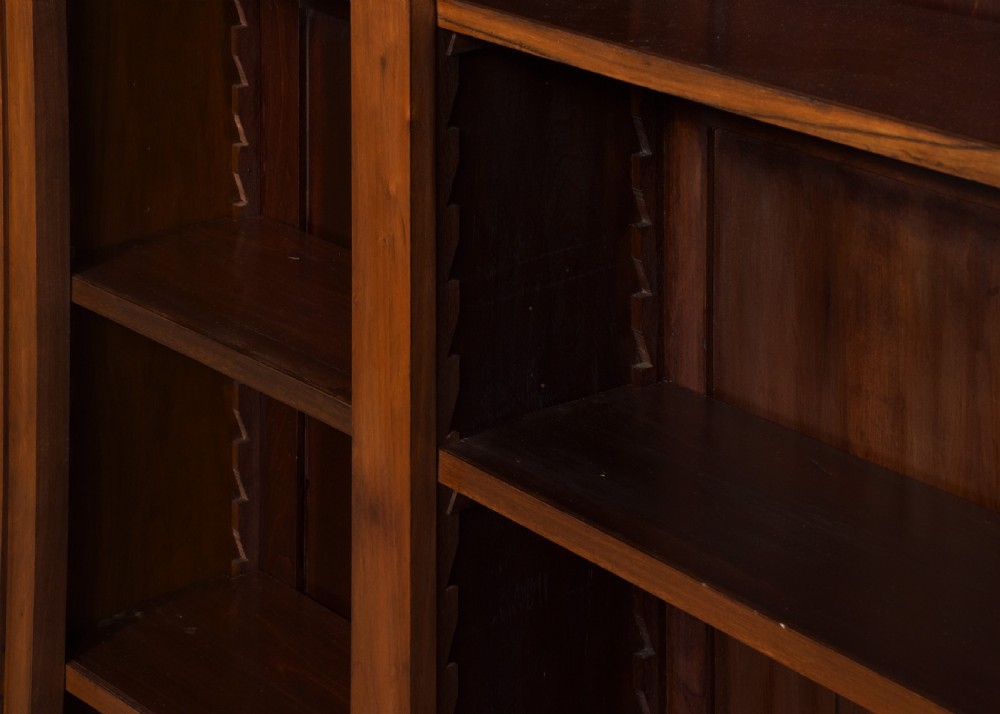 A tall mid-Victorian mahogany three-section open bookcase featuring a moulded top cornice and a solid plinth base filled with books. View VII