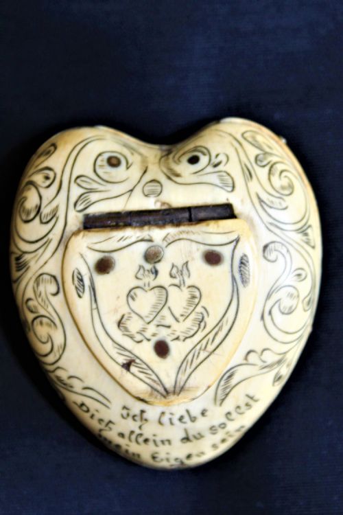 A Charming 19th Century Small Bone Heart Shaped Trinket Box with Inscribed Ink Decoration of Flowers and Lovers to the Reverse