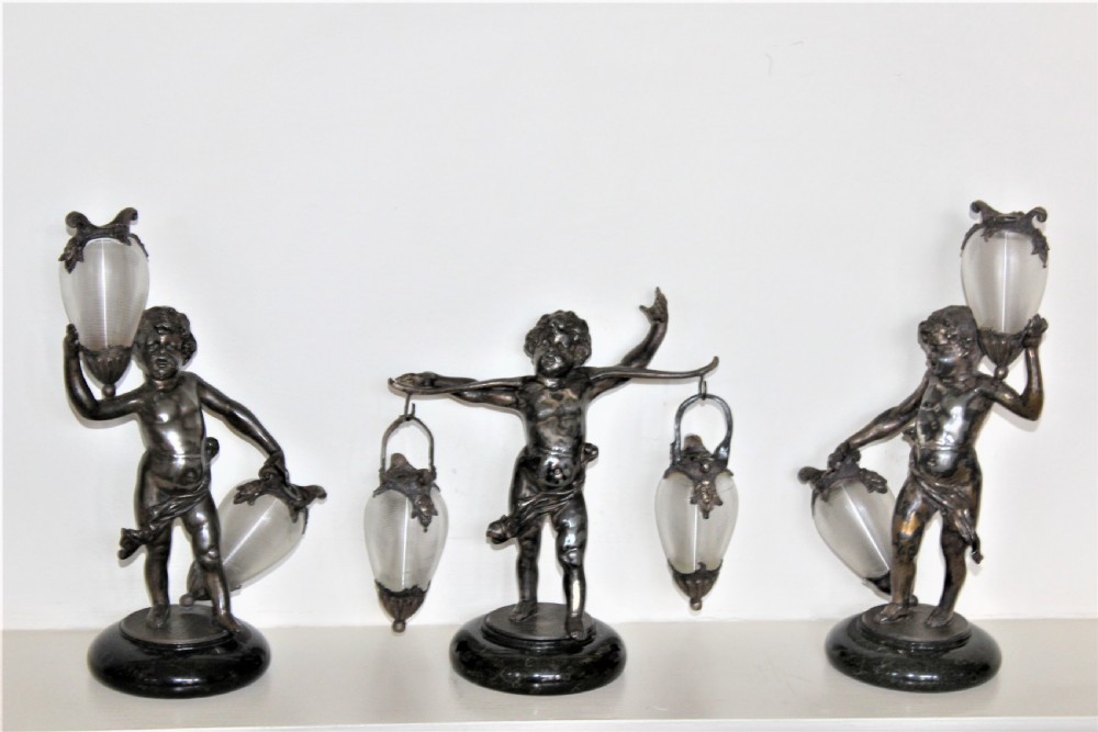 A delightful garniture of three chubby cherubs holding finely ribbed glass vases on marble French Circa 1900 View VI
