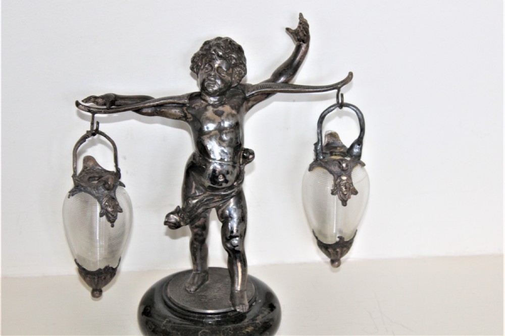 A delightful garniture of three chubby cherubs holding finely ribbed glass vases on marble French Circa 1900 View IV