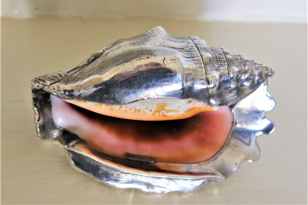 A very decorative conch shell skilfully hand covered in a sheath of heavy gauge silver and signed  View VII