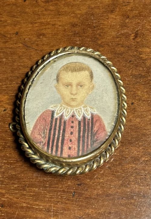A VERY CHARMING VICTORIAN PORTRAIT MINIATURE OF A YOUNG BOY IN A BROOCH