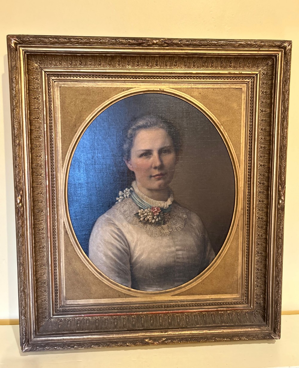 A late nineteenth-century oil portrait depicting a woman in a light dress within an oval mount and ornate rectangular gilt frame. View III