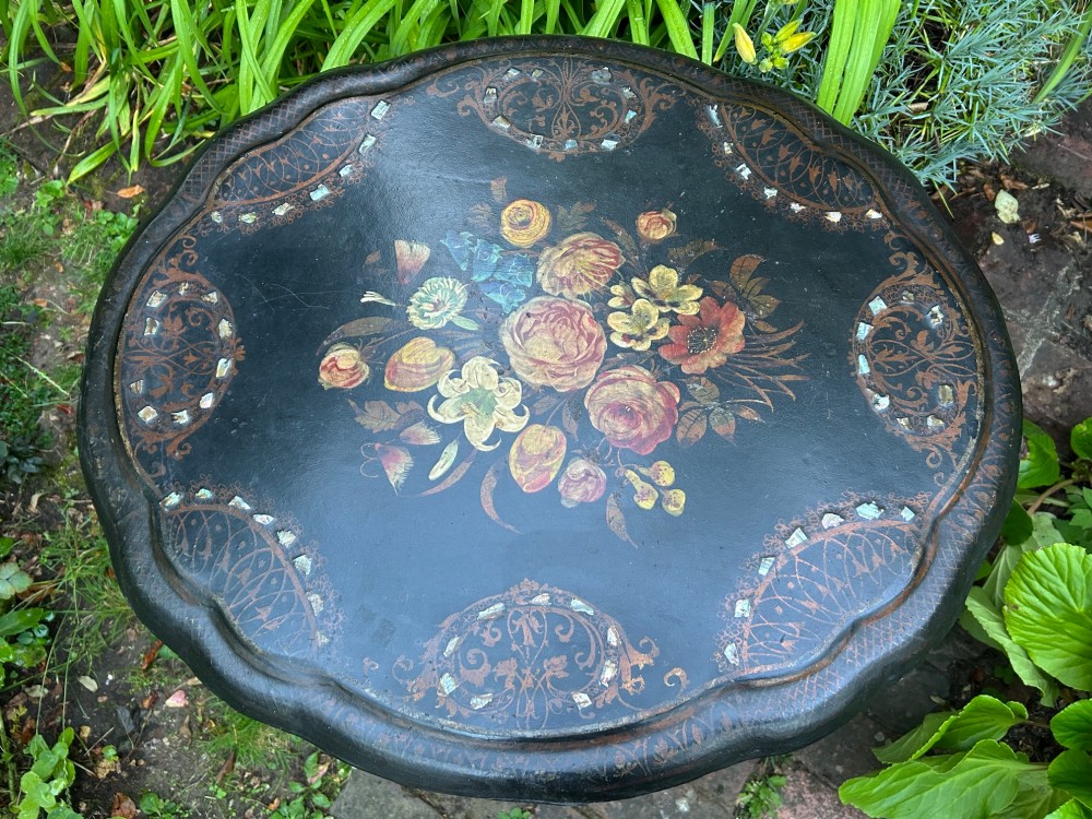 A Victorian black papier mache wine table featuring hand-painted botanical motifs, mother-of-pearl inlay, a scalloped edge, and a tripod base. View III