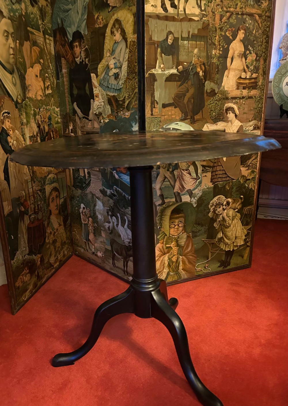 A Victorian black papier mache wine table featuring hand-painted botanical motifs, mother-of-pearl inlay, a scalloped edge, and a tripod base. View IV