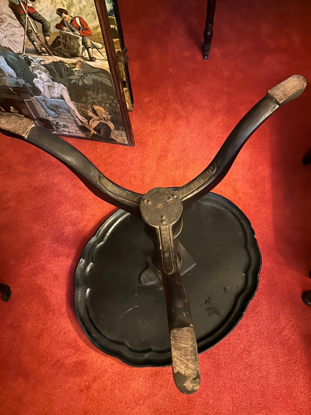 A Victorian black papier mache wine table featuring hand-painted botanical motifs, mother-of-pearl inlay, a scalloped edge, and a tripod base. View V