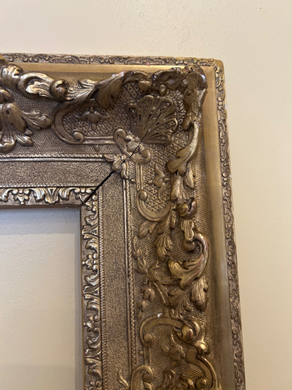 A rectangular 19th-century Rococo Revival style frame with intricate gilded floral, shell, and scrollwork gesso mouldings. View IV